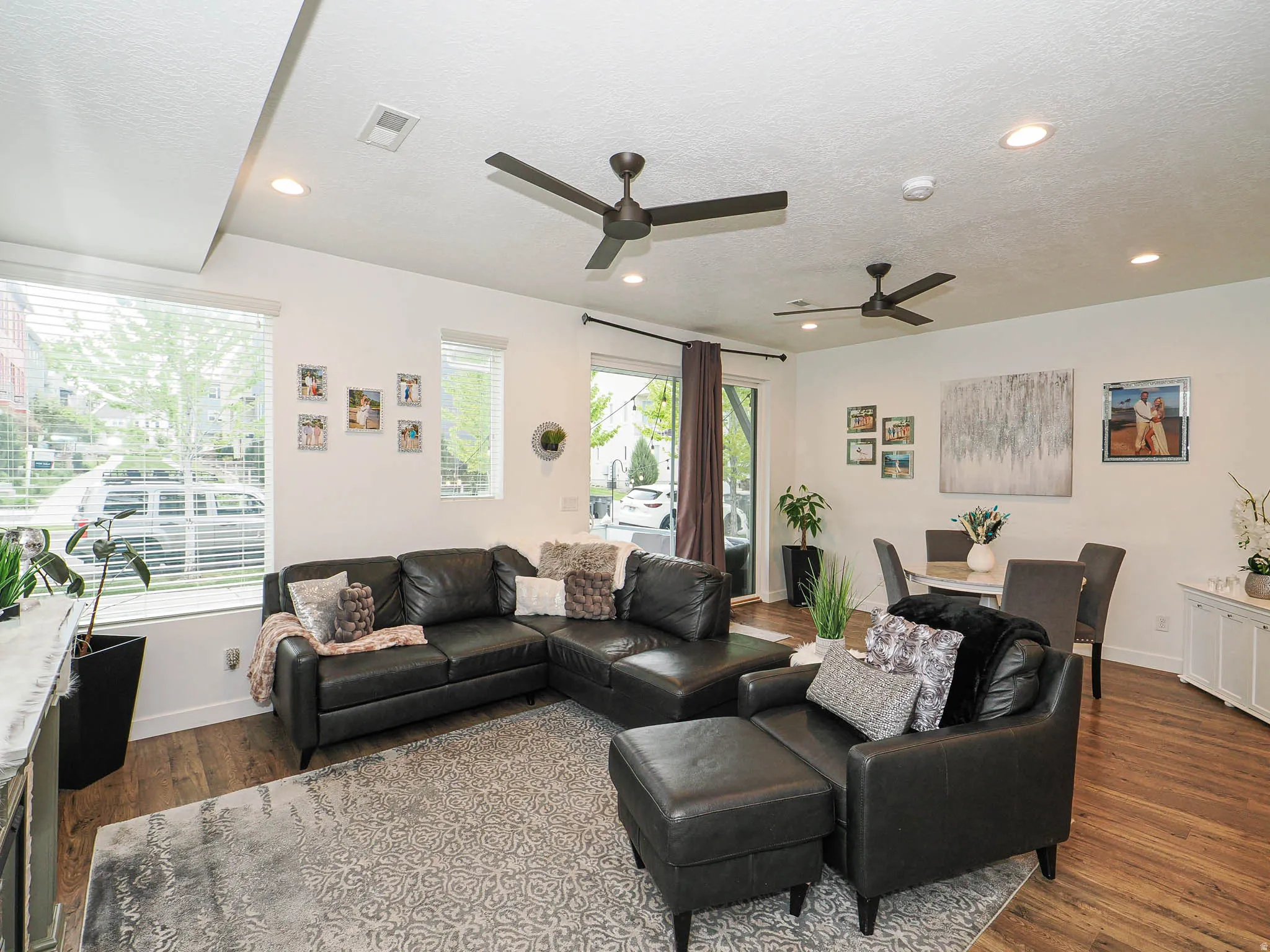 Open concept living area featuring wood-finish flooring, recessed lighting, and dual ceiling fans