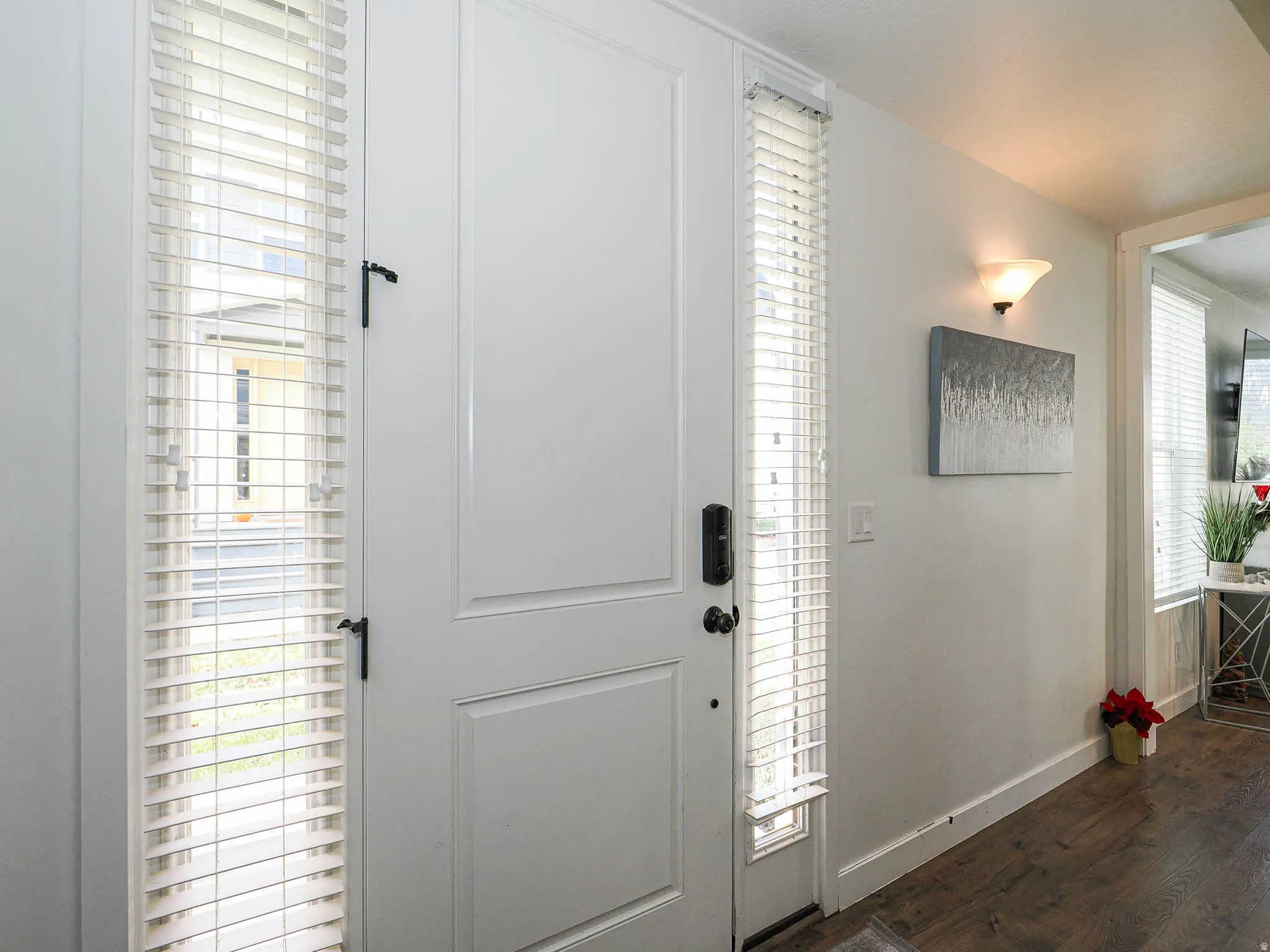 Foyer entrance with dark wood-type flooring and healthy amount of natural light