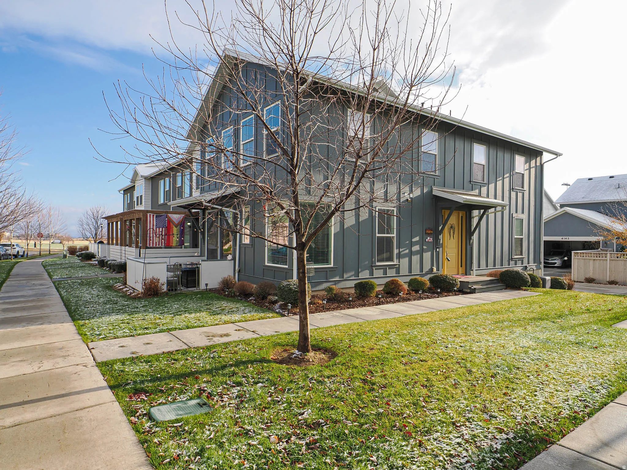 View of front of home featuring board and batten siding and a front lawn