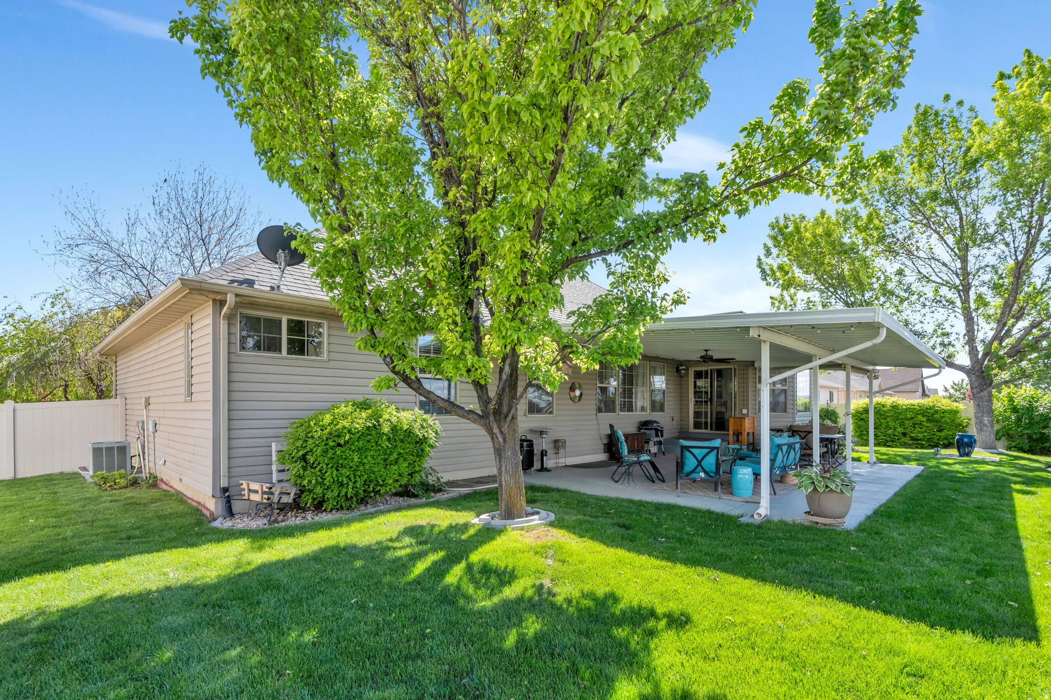 Back of property featuring ceiling fan and a patio
