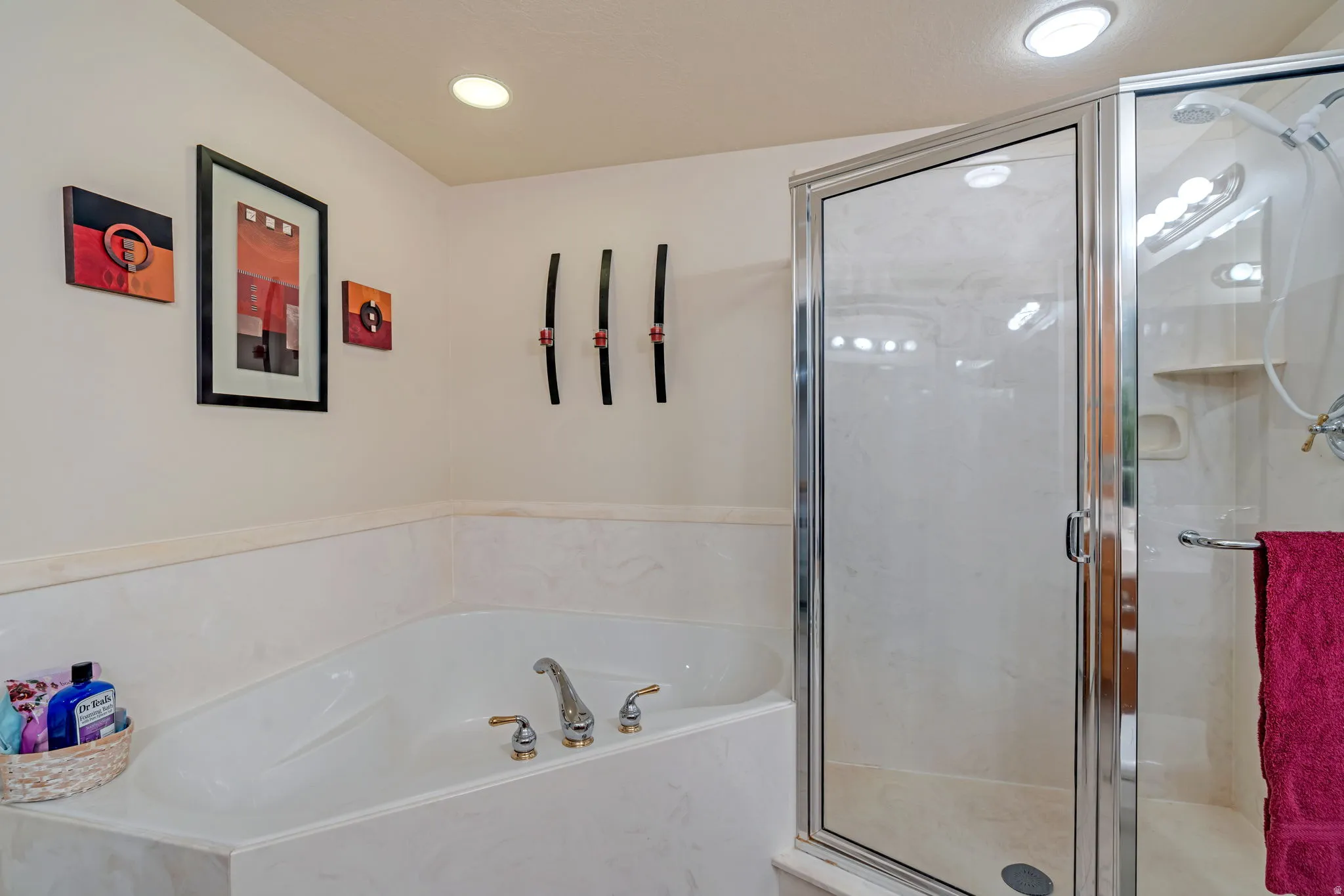 Bathroom featuring a marble finish shower and a bath
