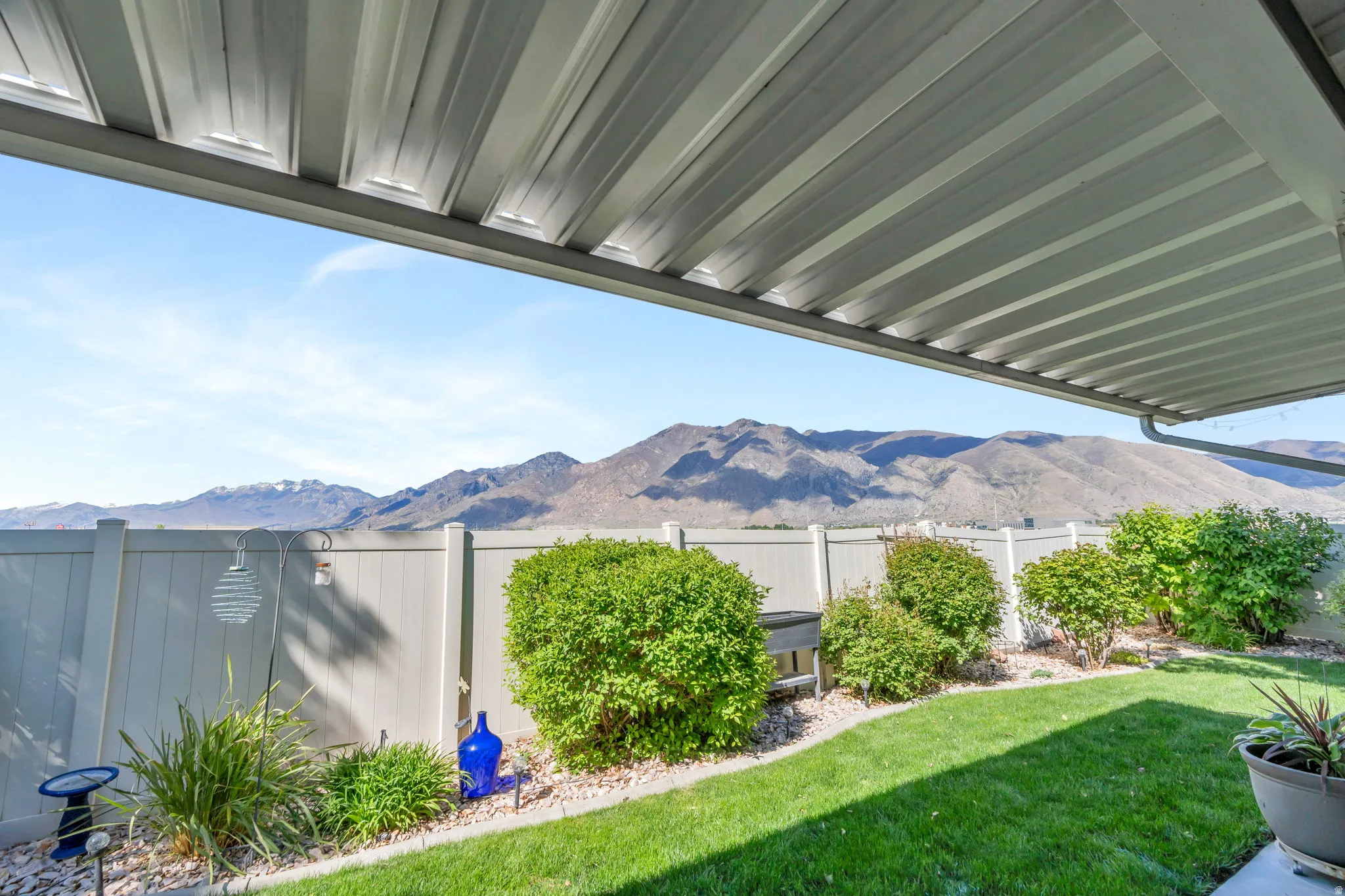 Fenced backyard featuring a mountain view