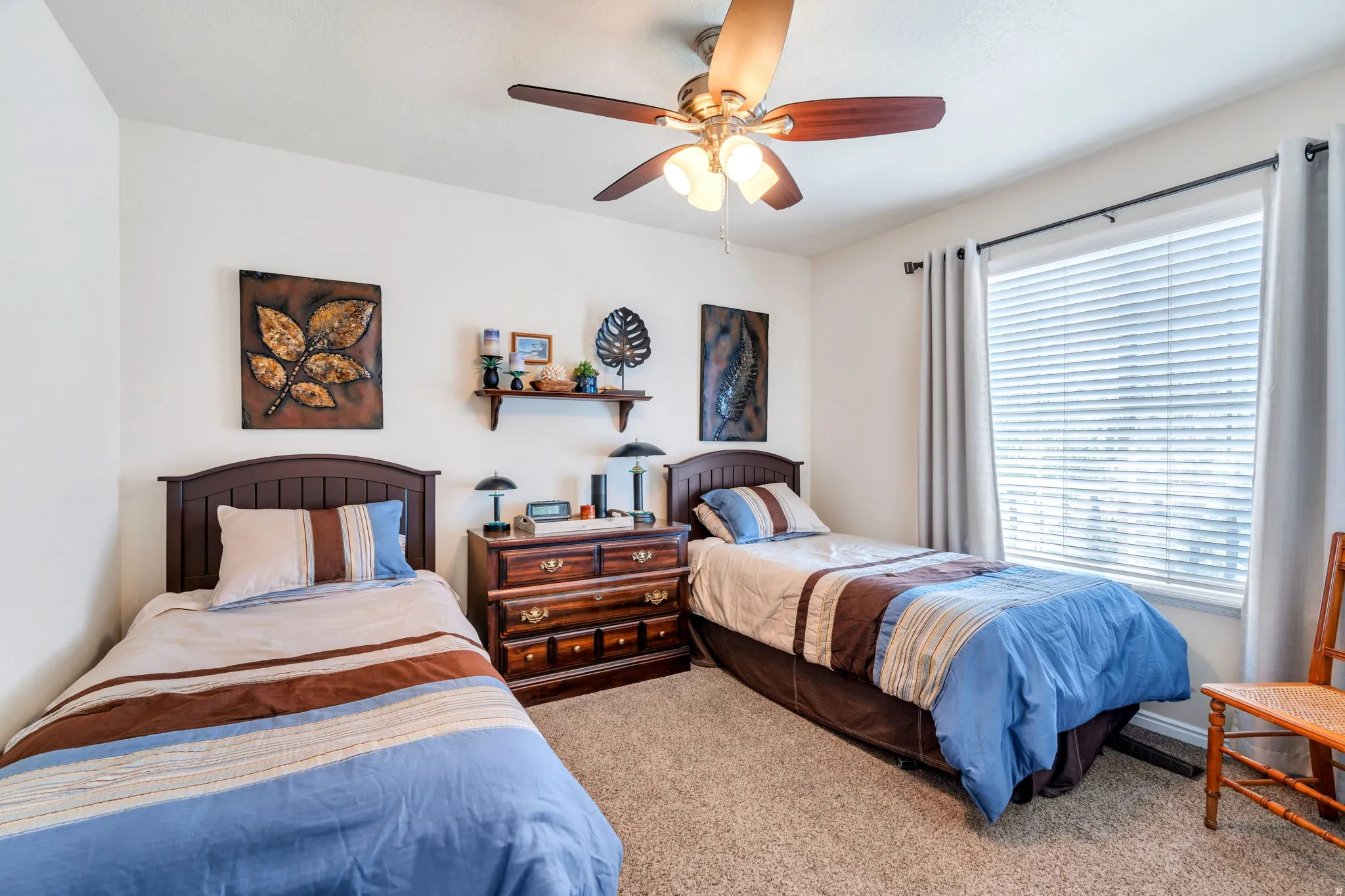 Carpeted bedroom with ceiling fan