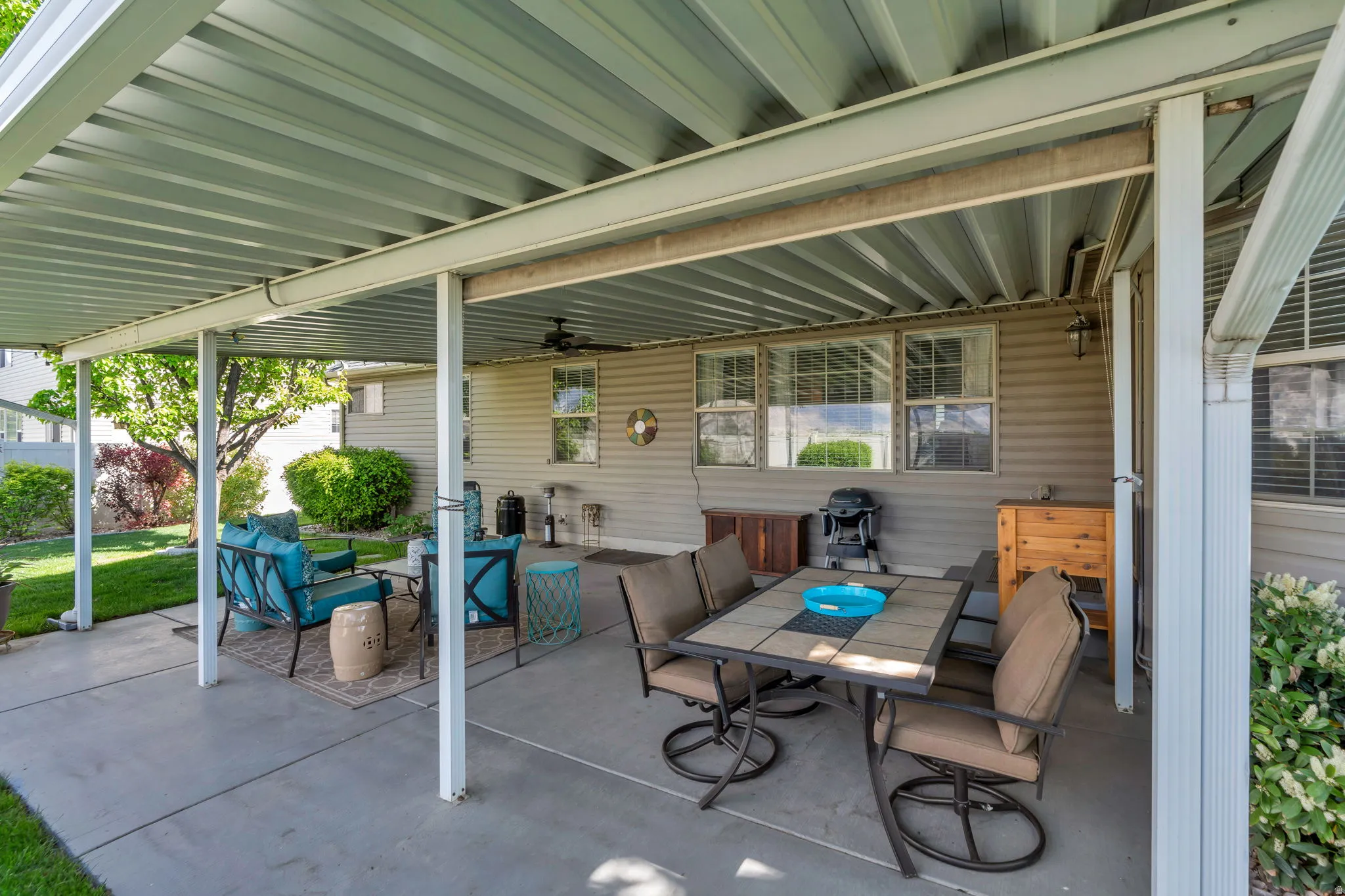 View of patio with an outdoor living / dining area and ceiling fan