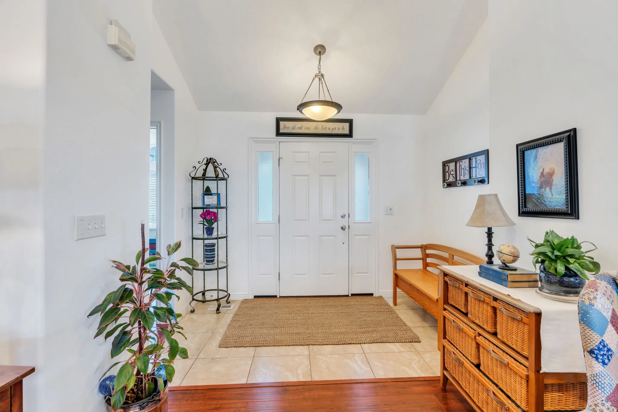 Entrance foyer with vaulted ceiling and light tile patterned flooring