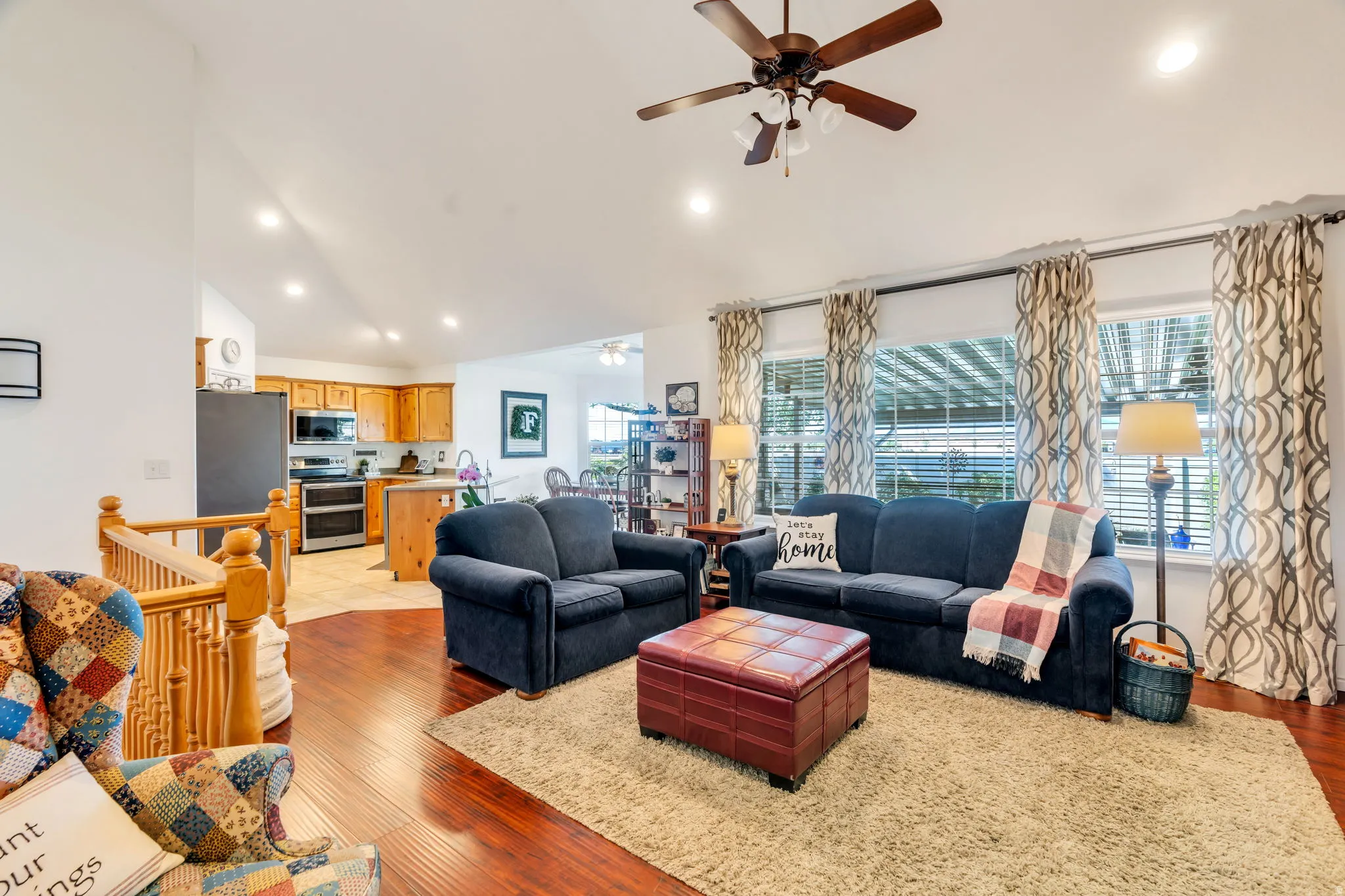 Living area featuring a ceiling fan, wood finished floors, recessed lighting, and lofted ceiling