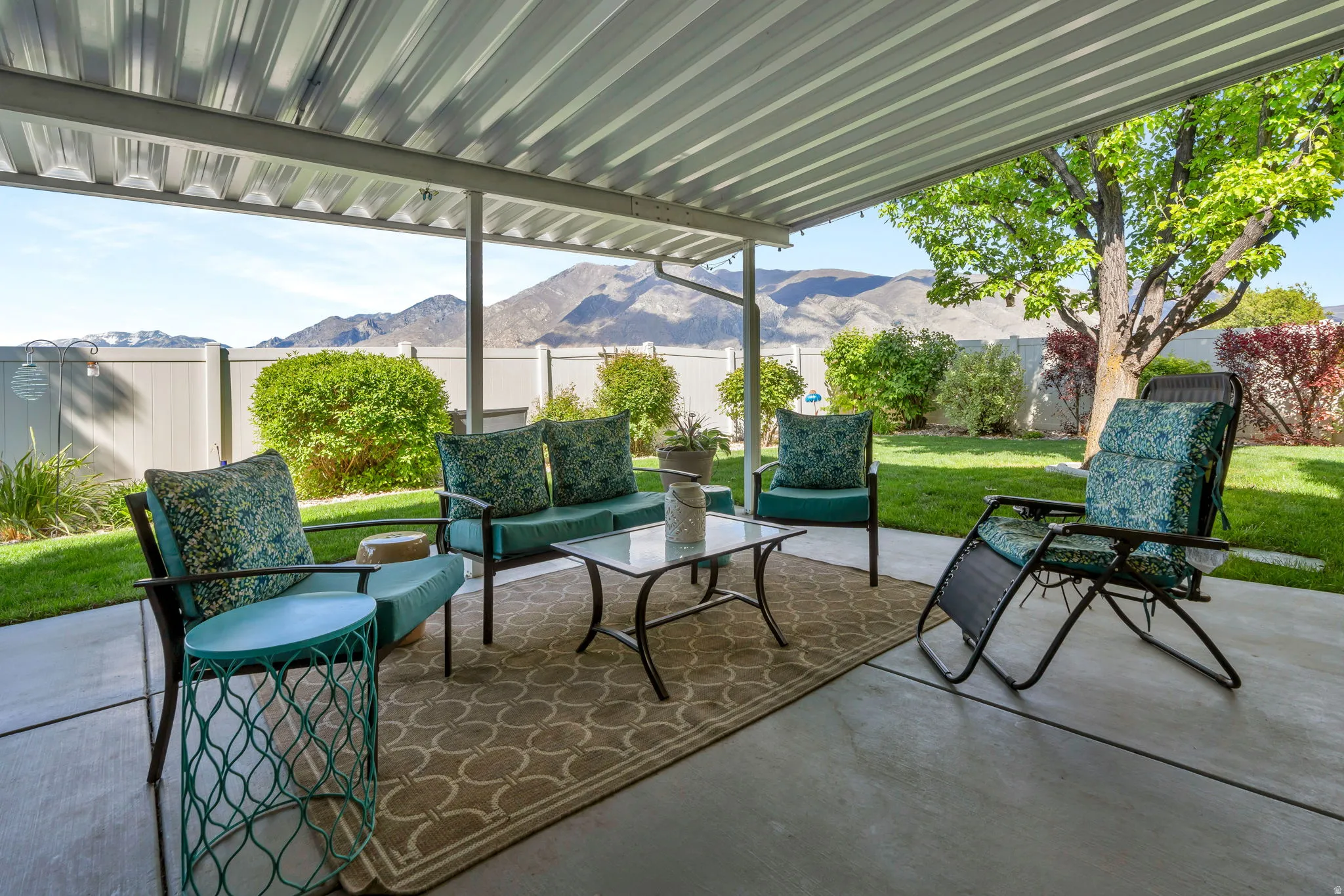 Fenced backyard featuring an outdoor hangout area, a mountain view, and a patio