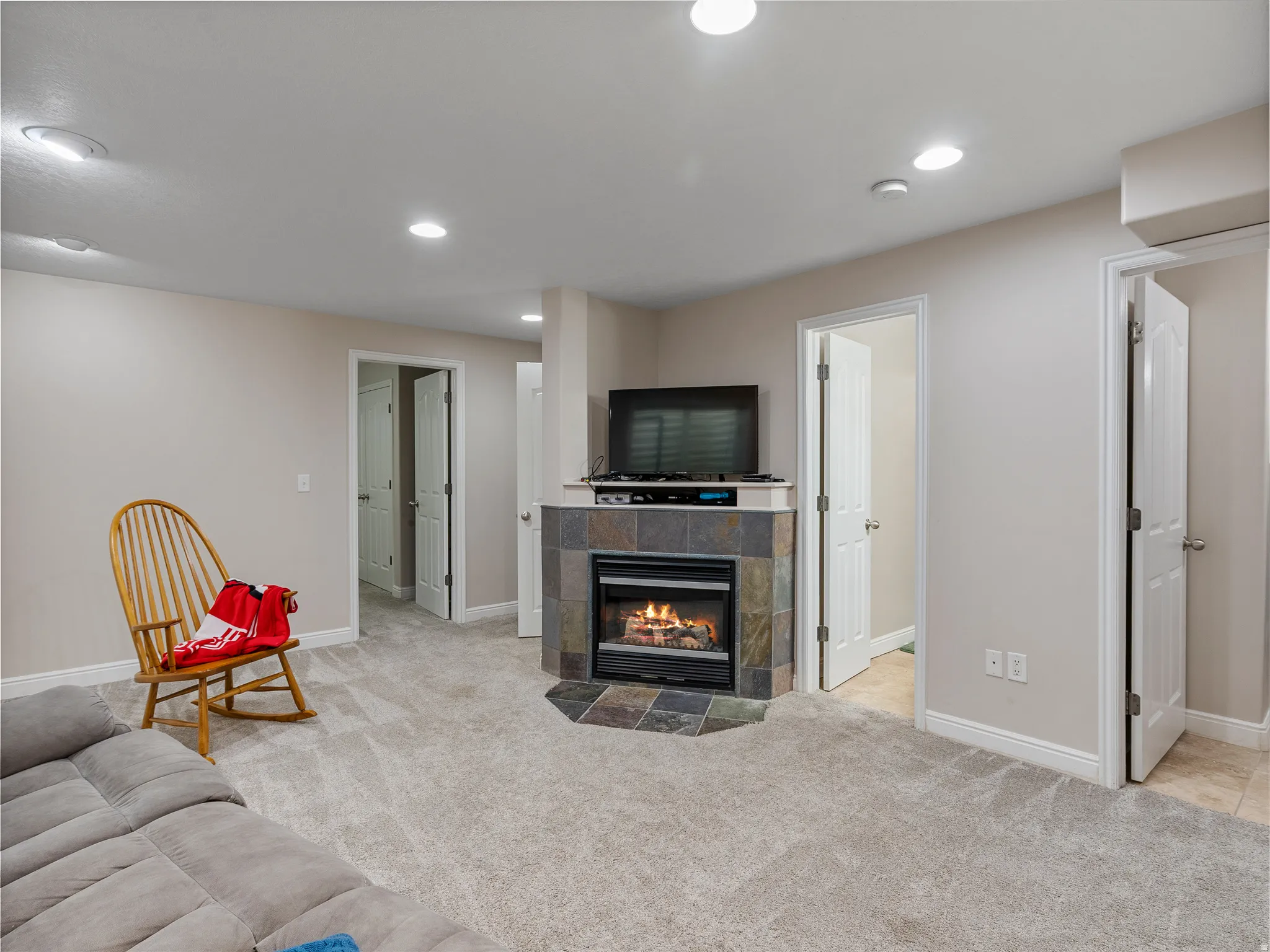 Living area featuring a corner fireplace with a slate tile surround and hearth