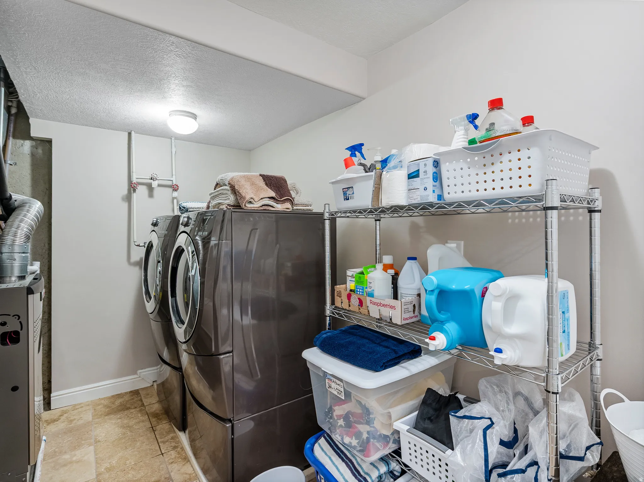 Dedicated laundry area featuring tile flooring and built-in mechanicals