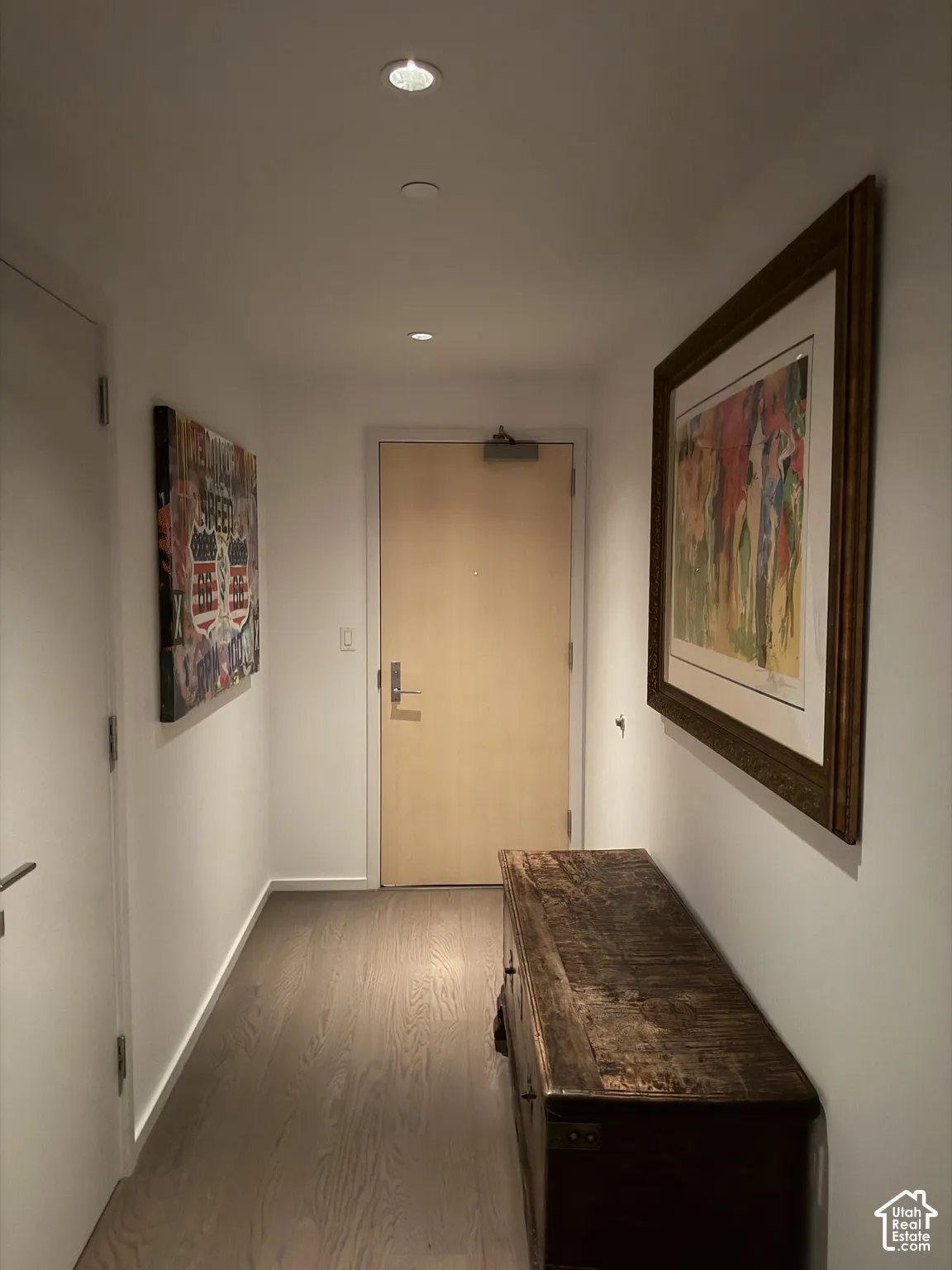 Recessed ceiling lighting, light wood-finish flooring, and white walls