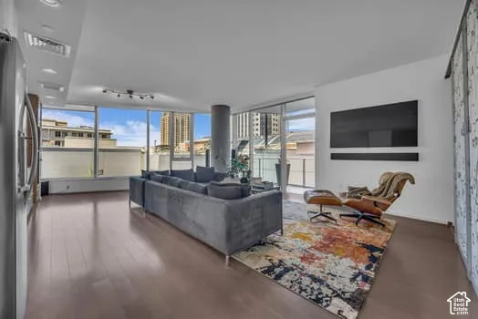 Living room with dark wood-type flooring and rail lighting