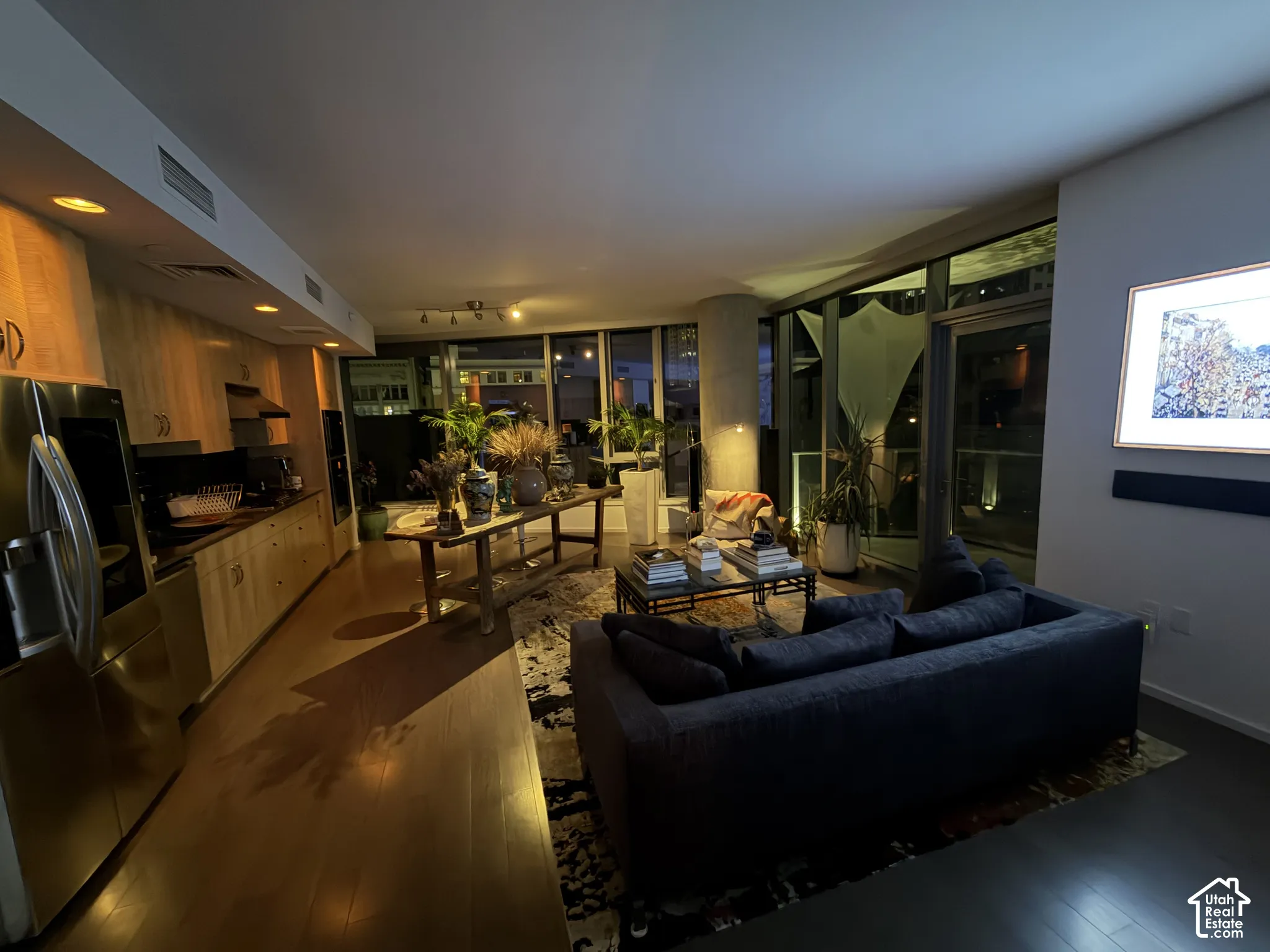 Integrated kitchen with wood-finish cabinetry and stainless steel appliances