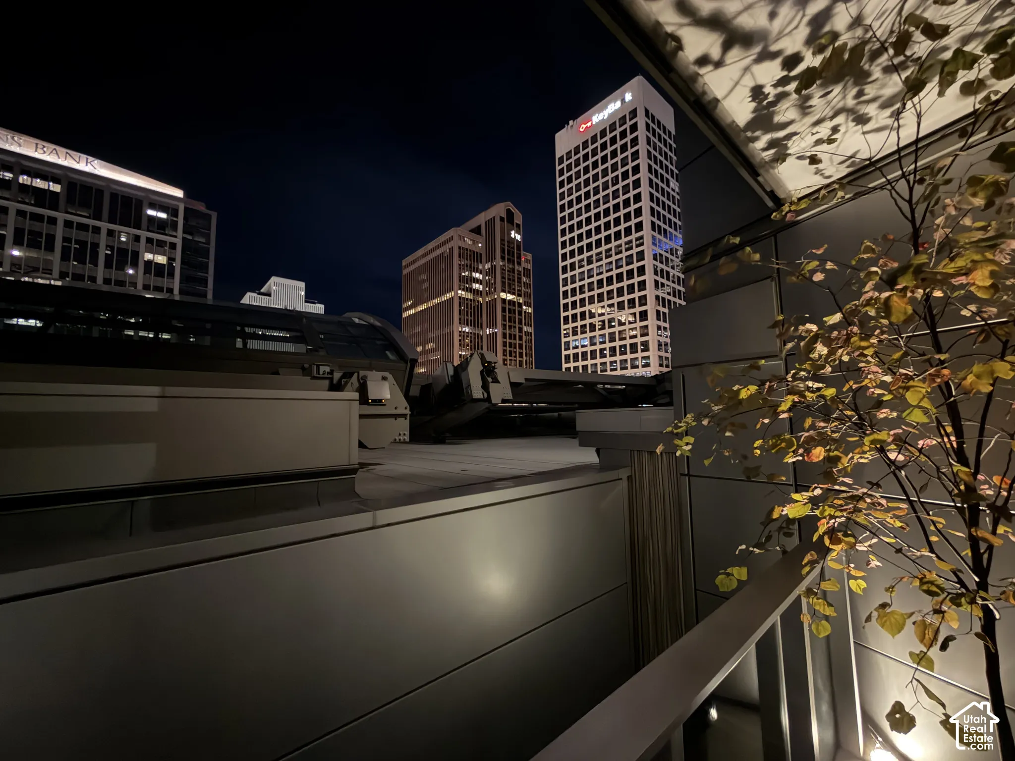 Modern exterior with architectural paneling, integrated lighting, and a metal railing