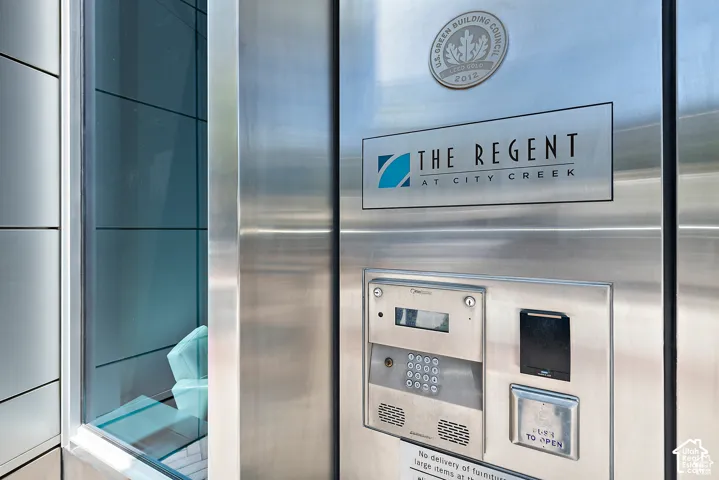 Stainless steel paneling featuring a building nameplate and intercom system