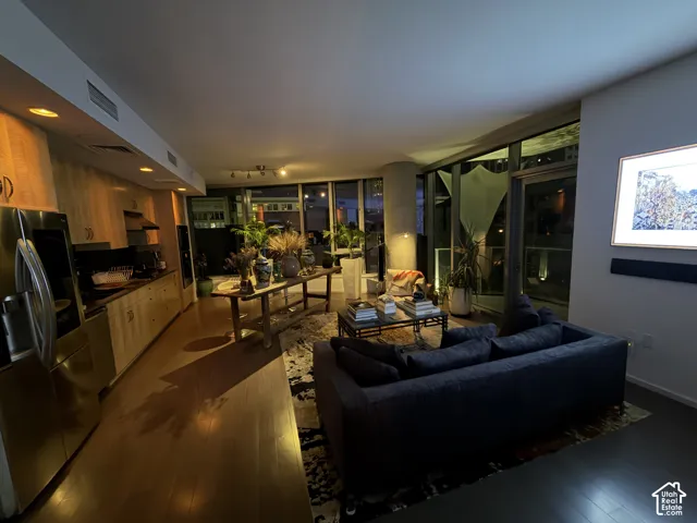 Integrated kitchen with wood-finish cabinetry and stainless steel appliances