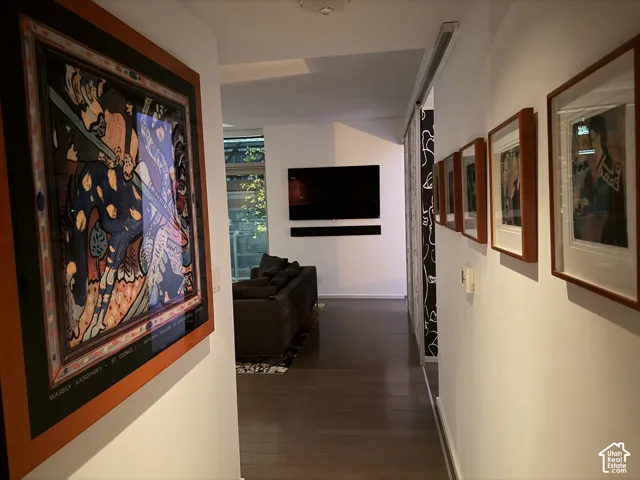 Hardwood flooring throughout, recessed lighting, and white walls
