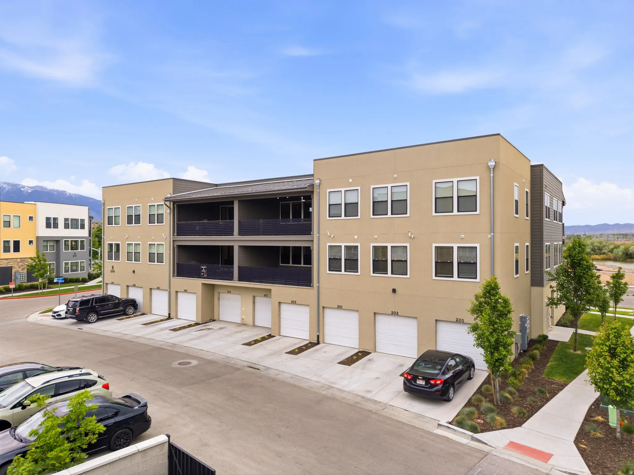 Contemporary multi-story residential building with private garages