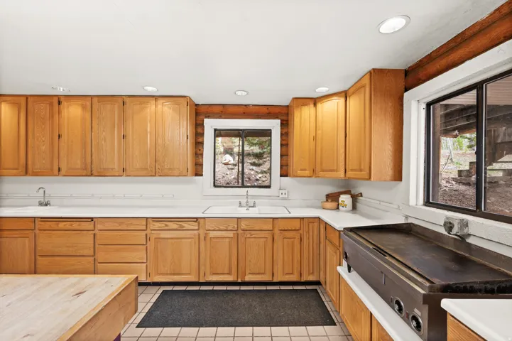Kitchen featuring light wood cabinetry, white countertops, tile flooring, and recessed lighting