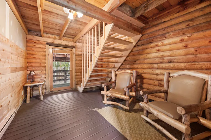 Interior space featuring log wall construction and wood-finish flooring