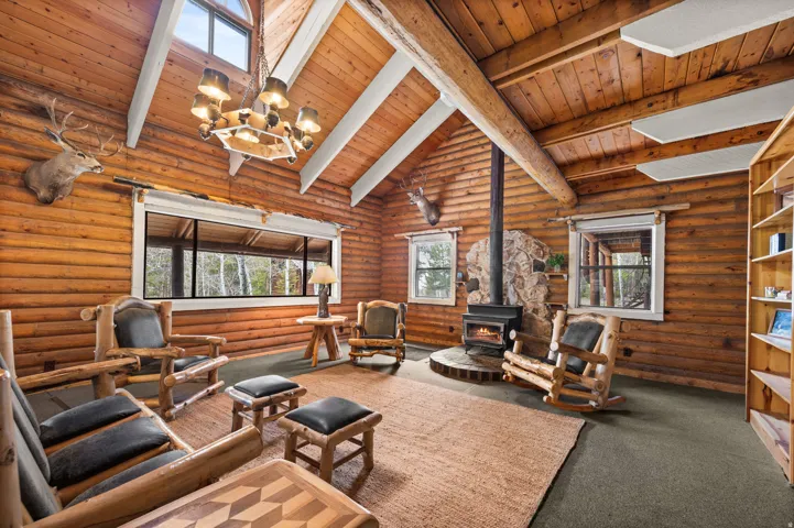 Vaulted wood-plank ceiling with exposed log beam