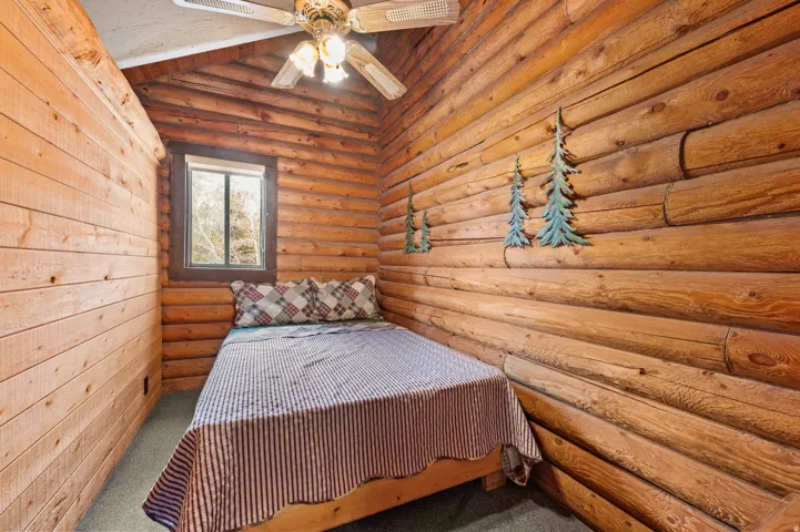 Natural wood walls featuring log construction and shiplap paneling