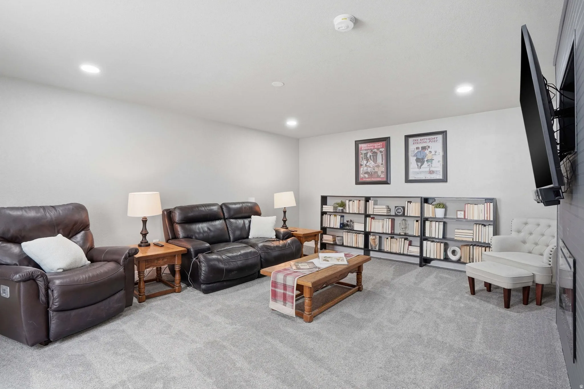 Spacious room featuring light gray walls and recessed lighting