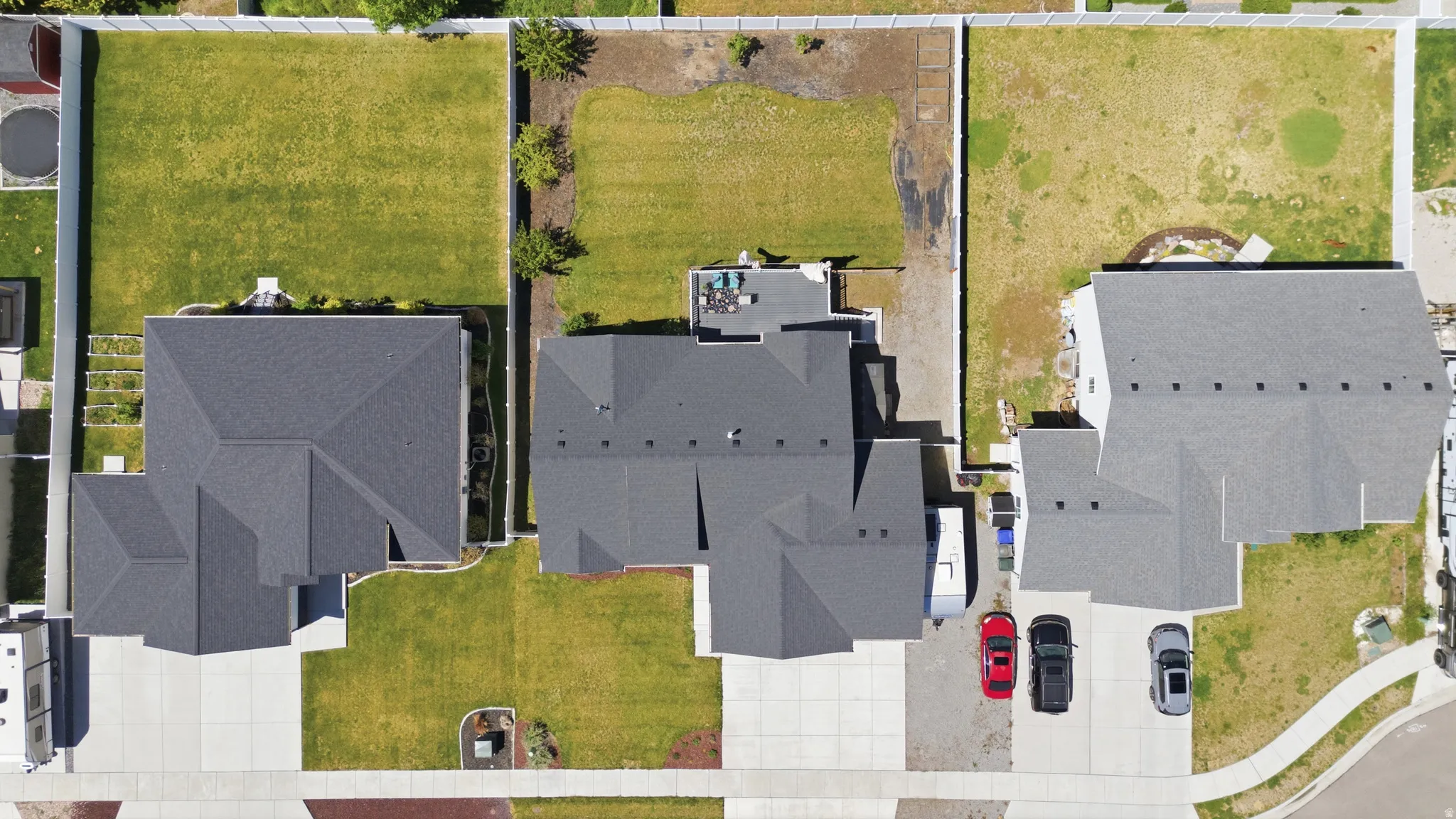 Aerial perspective showcasing a residential property with a dark gray asphalt shingle roof