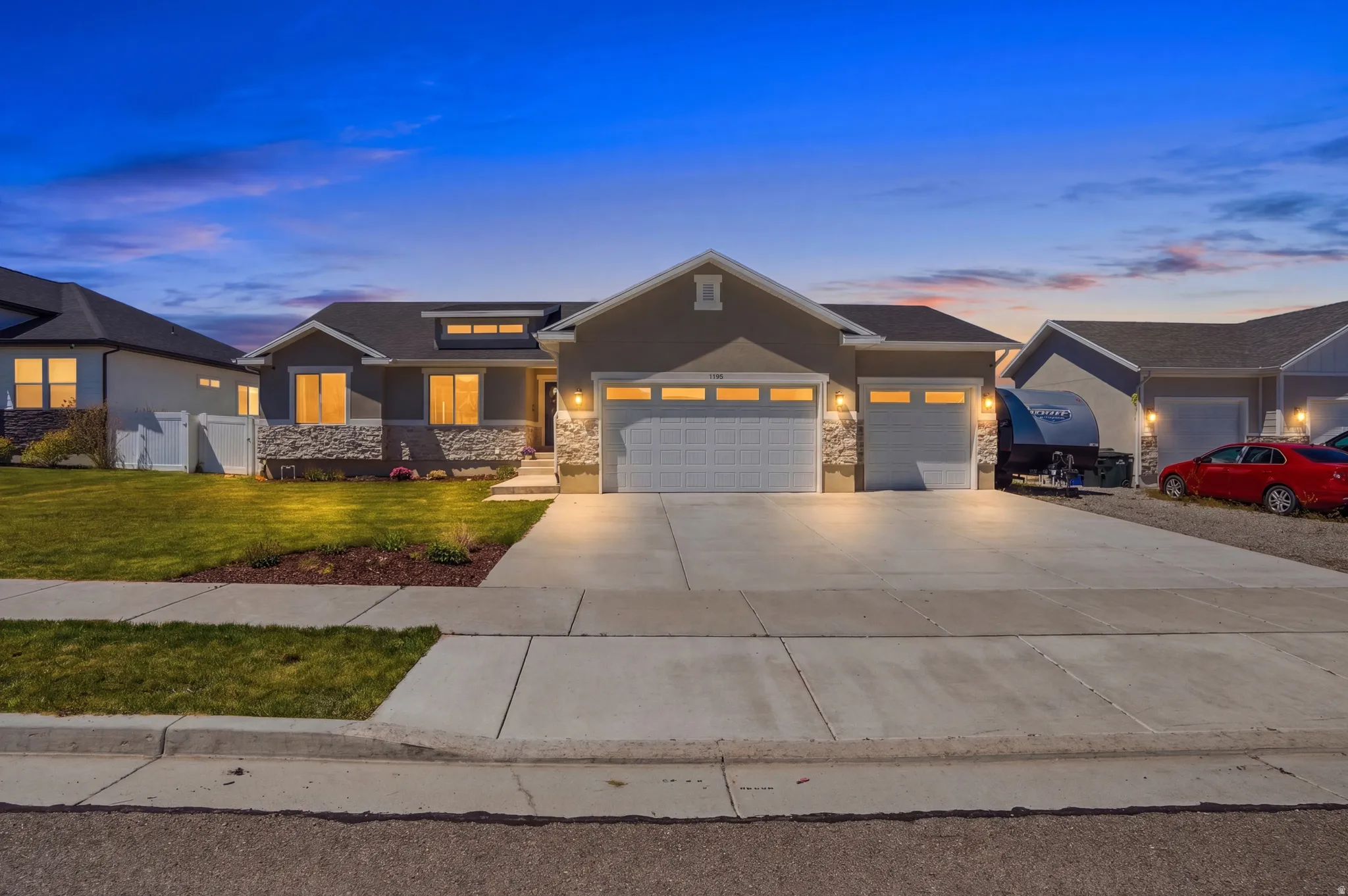 Ranch-style exterior with stone veneer accents and a three-car garage