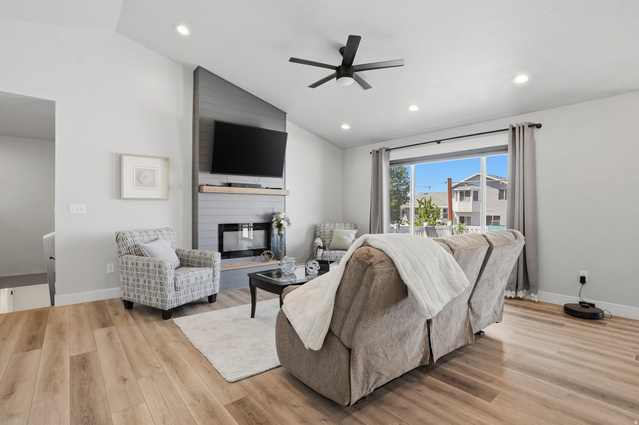 Spacious living area featuring vaulted ceilings