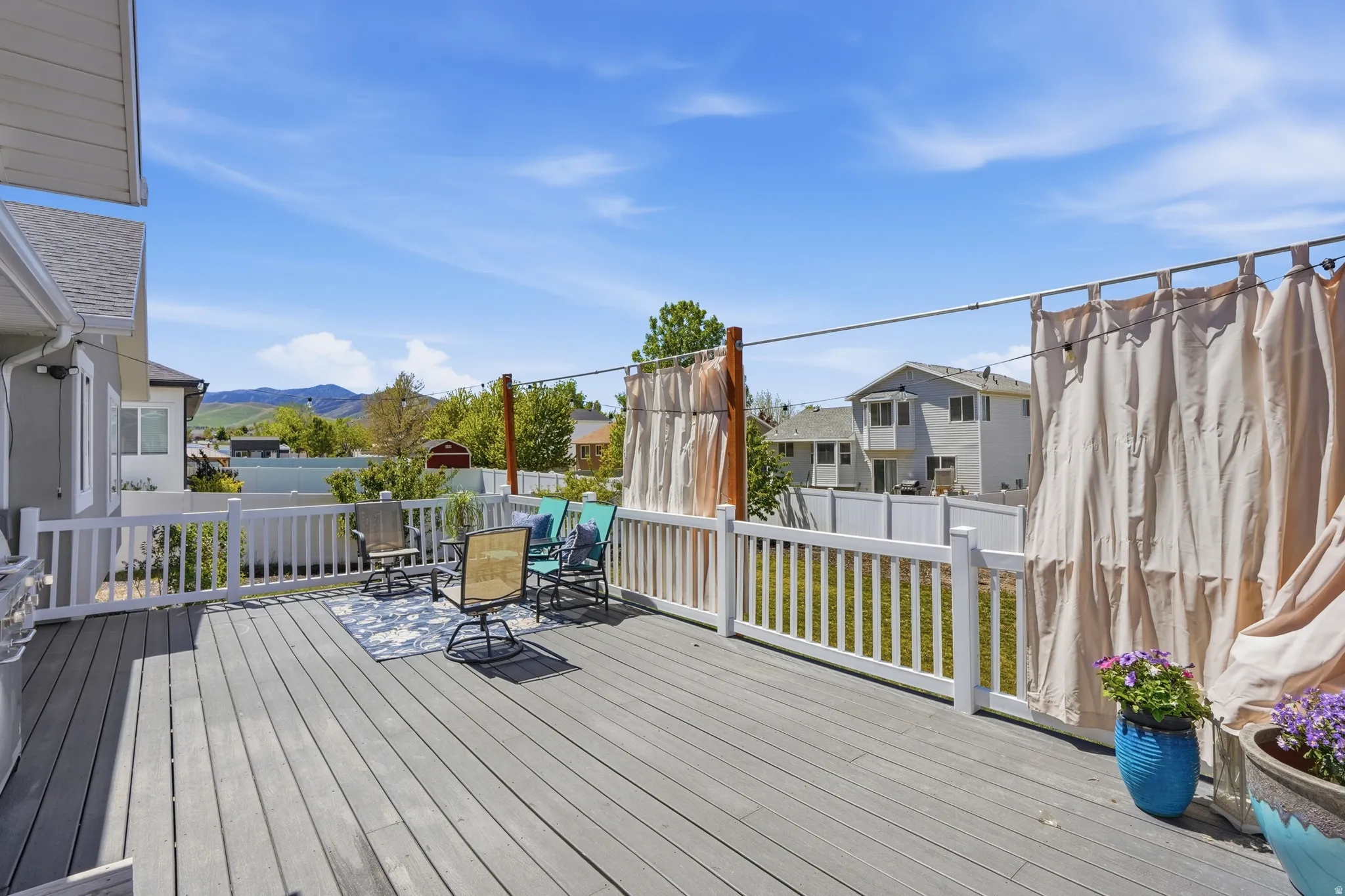 Expansive outdoor deck featuring grey composite decking and white railing