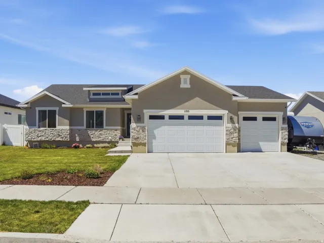 Contemporary-style residence featuring a combination of stucco and stone veneer exterior