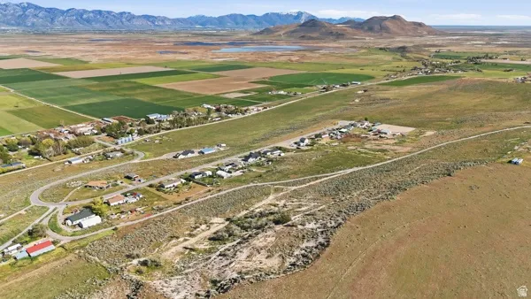 Aerial perspective showcasing extensive undeveloped land with distant mountain ranges