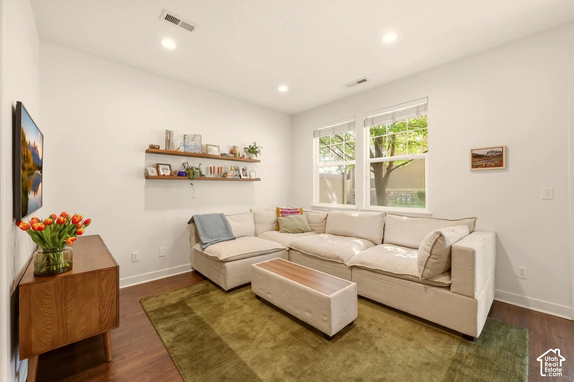 Living area featuring wide plank wood-finish flooring and recessed lighting