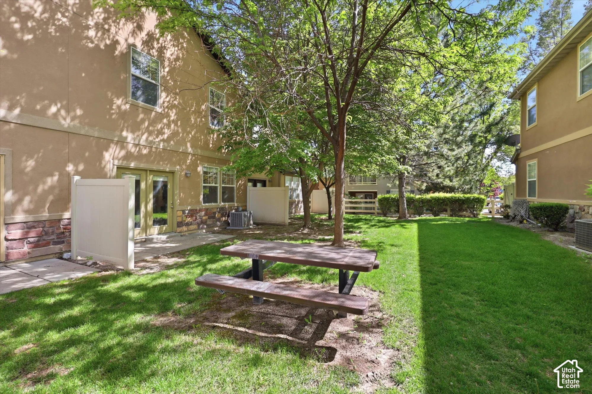 Expansive green space featuring mature trees and a manicured lawn