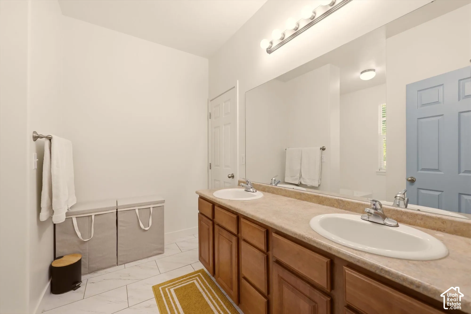 Double vanity with laminate countertops, two undermount sinks, and chrome faucets