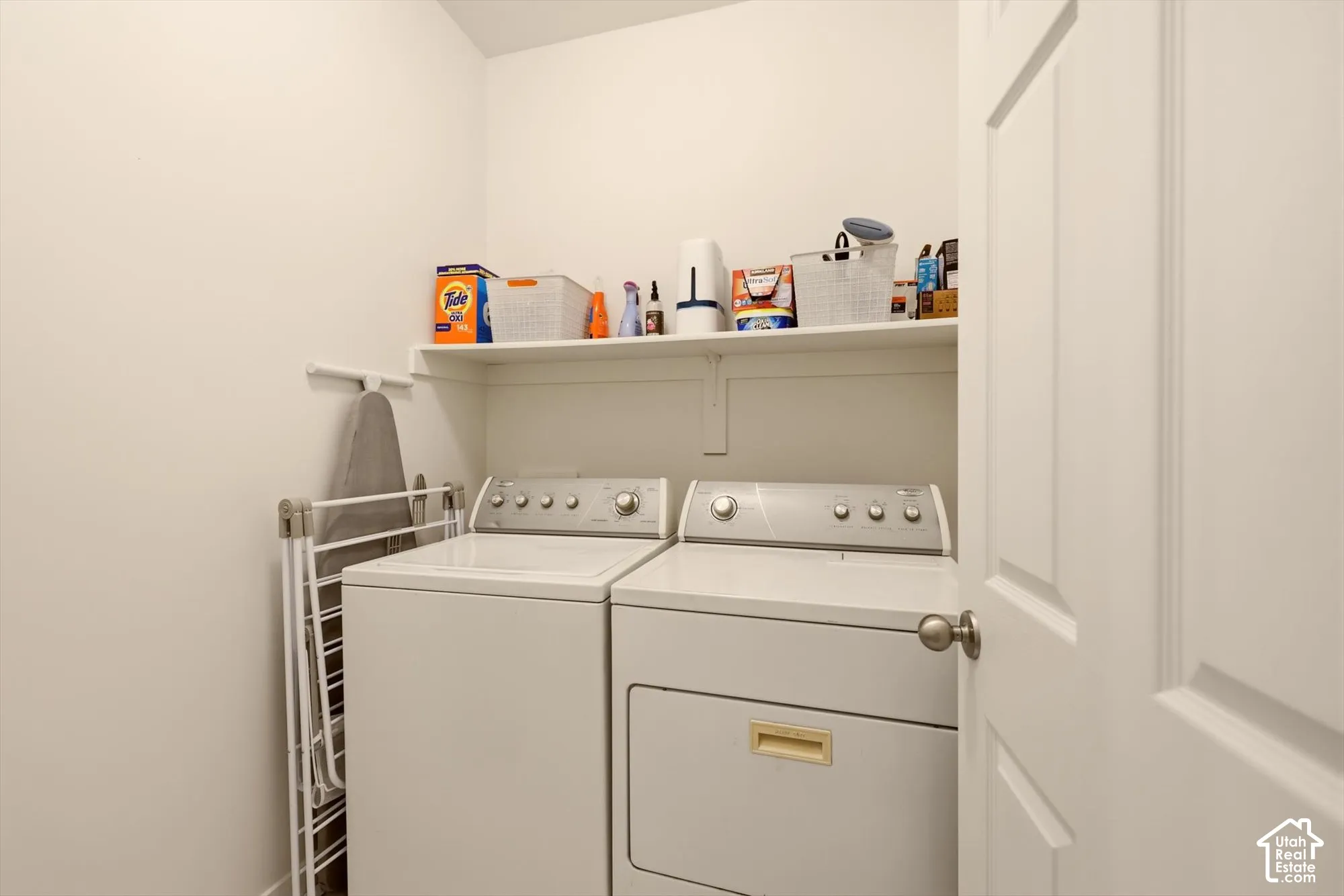 Dedicated laundry area featuring a built-in white shelf, providing vertical storage