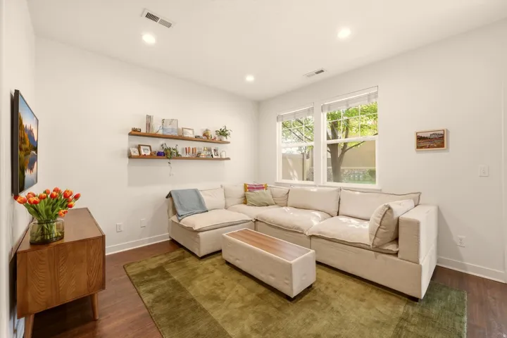 Living area featuring wide plank wood-finish flooring and recessed lighting