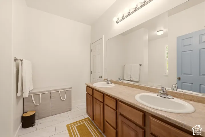 Double vanity with laminate countertops, two undermount sinks, and chrome faucets