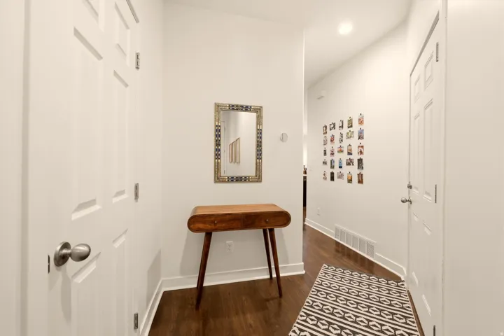 Entryway featuring wood-finish flooring, white paneled doors, and recessed ceiling lighting