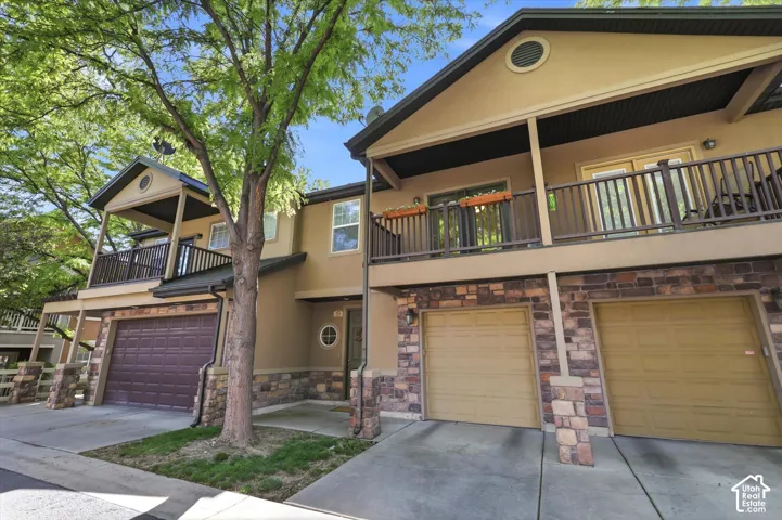 Townhome exterior with stucco siding and stone-clad accents