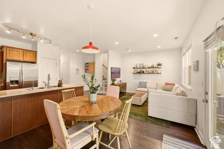 Open-concept living area featuring wood-finish flooring, recessed lighting, and white walls