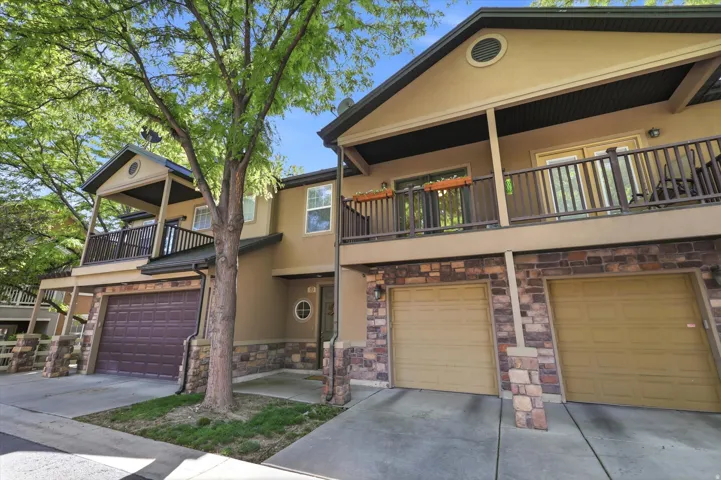 Townhome exterior with stucco siding and stone-clad accents