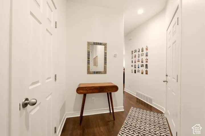 Entryway featuring wood-finish flooring, white paneled doors, and recessed ceiling lighting