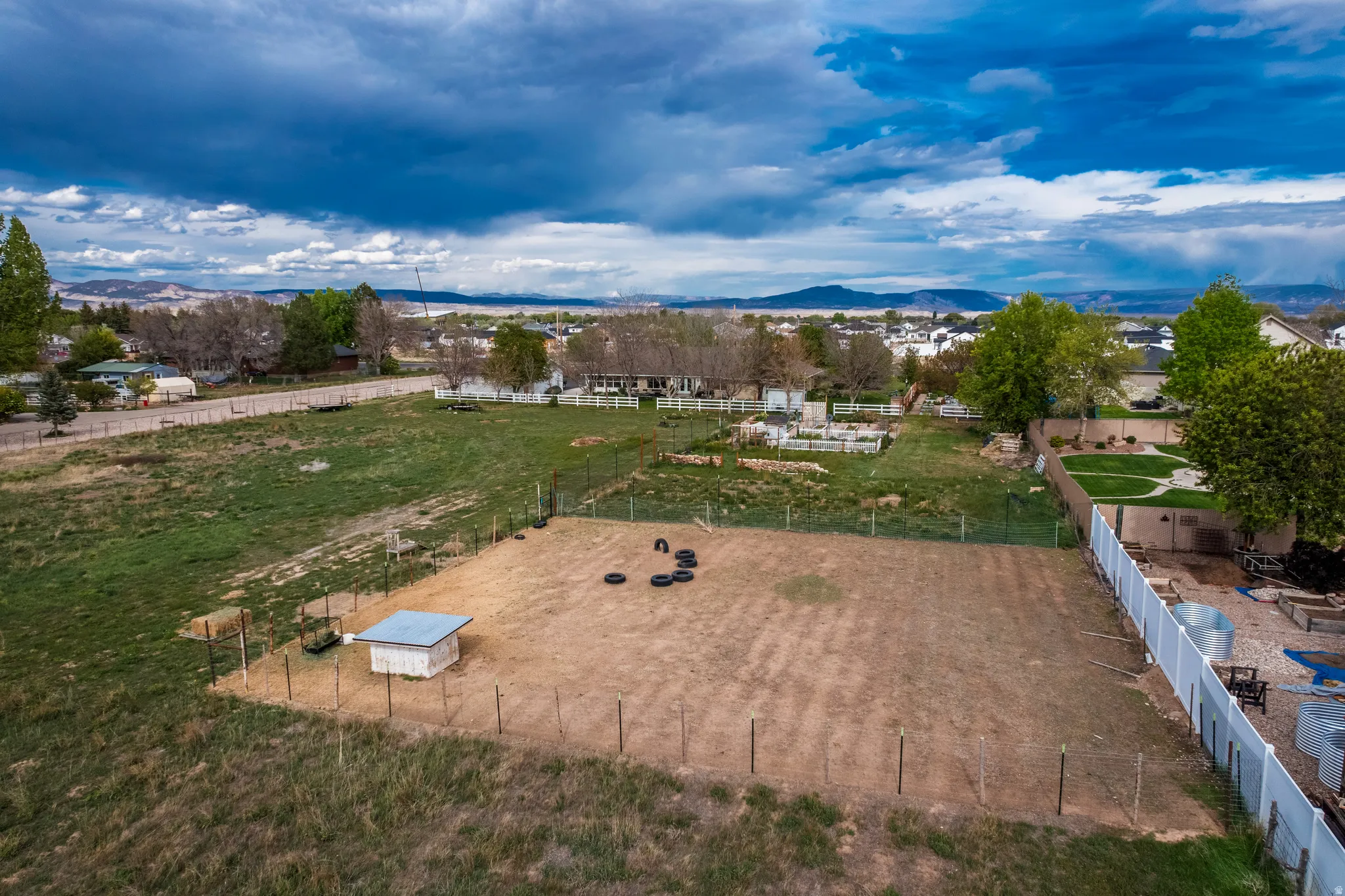 Expansive property featuring a fenced paddock area, a small shed structure, and a perimeter fence