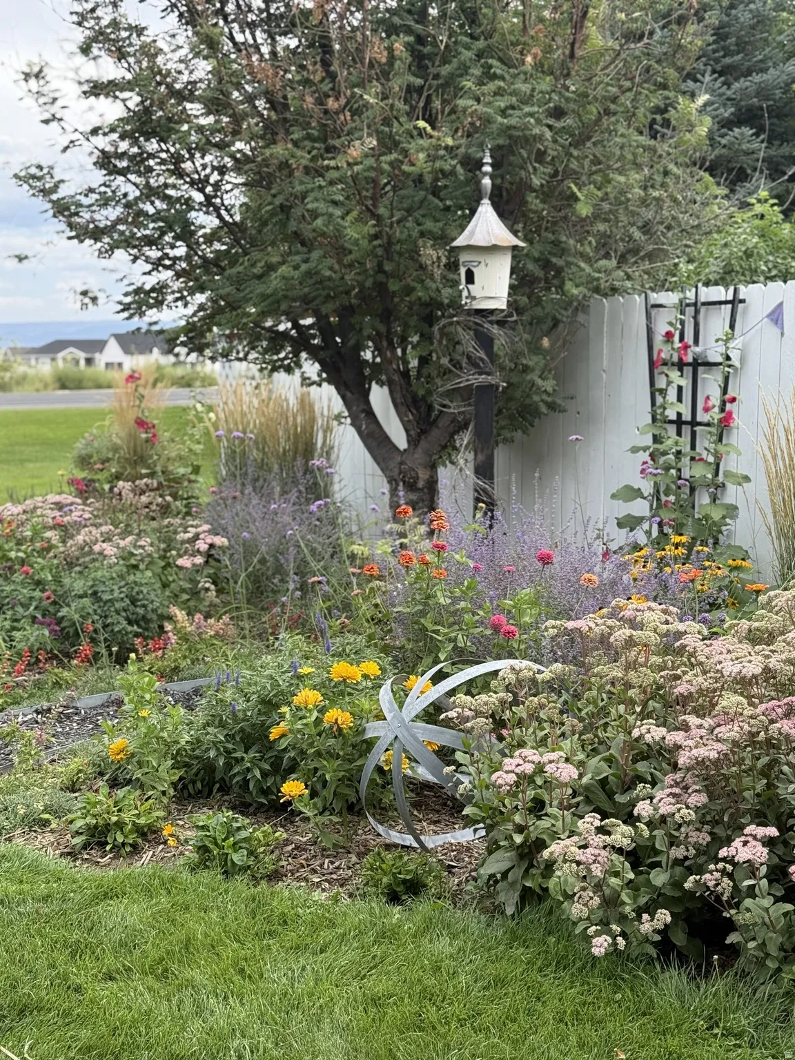 Manicured lawn with a vibrant mixed-flower garden