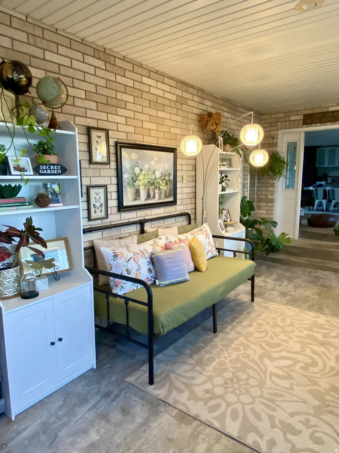 Exposed brick wall with a white paneled ceiling