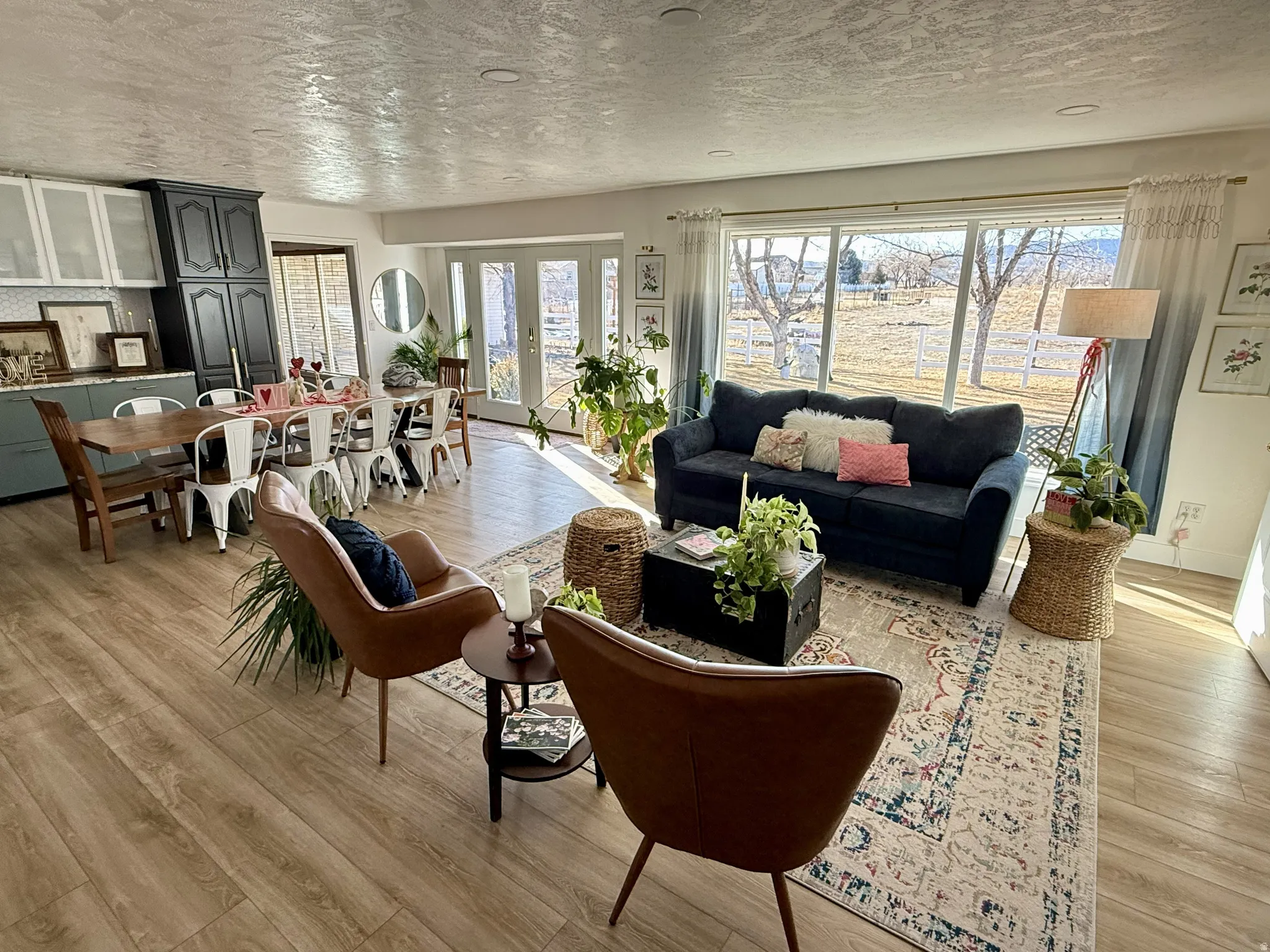Open-concept living space featuring wood-finish flooring, recessed lighting, and a large dining area with built-in cabinetry