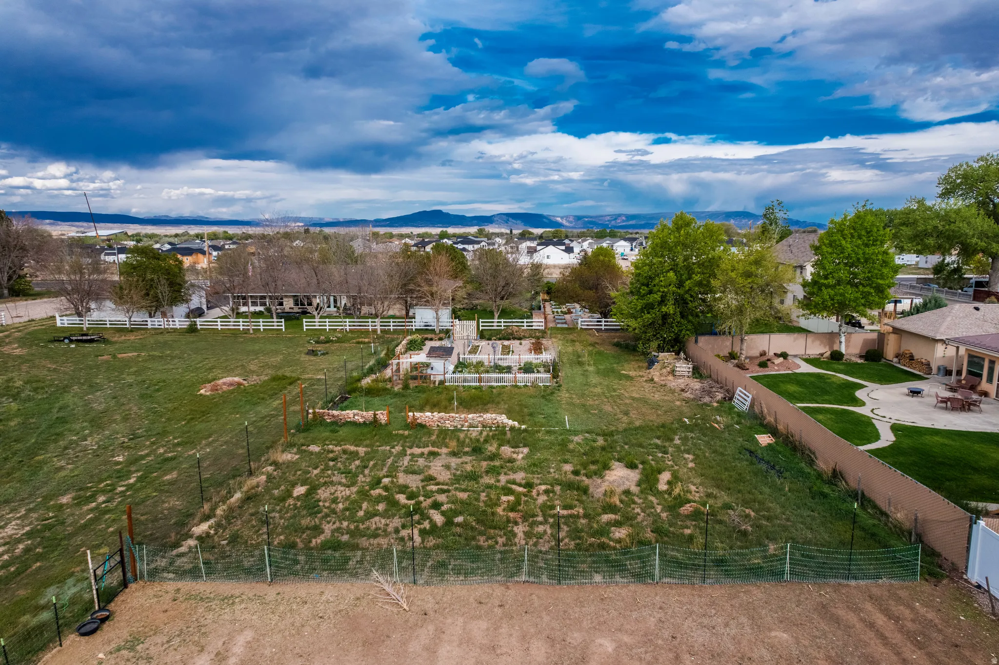 Expansive lot featuring varied terrain and a defined garden area