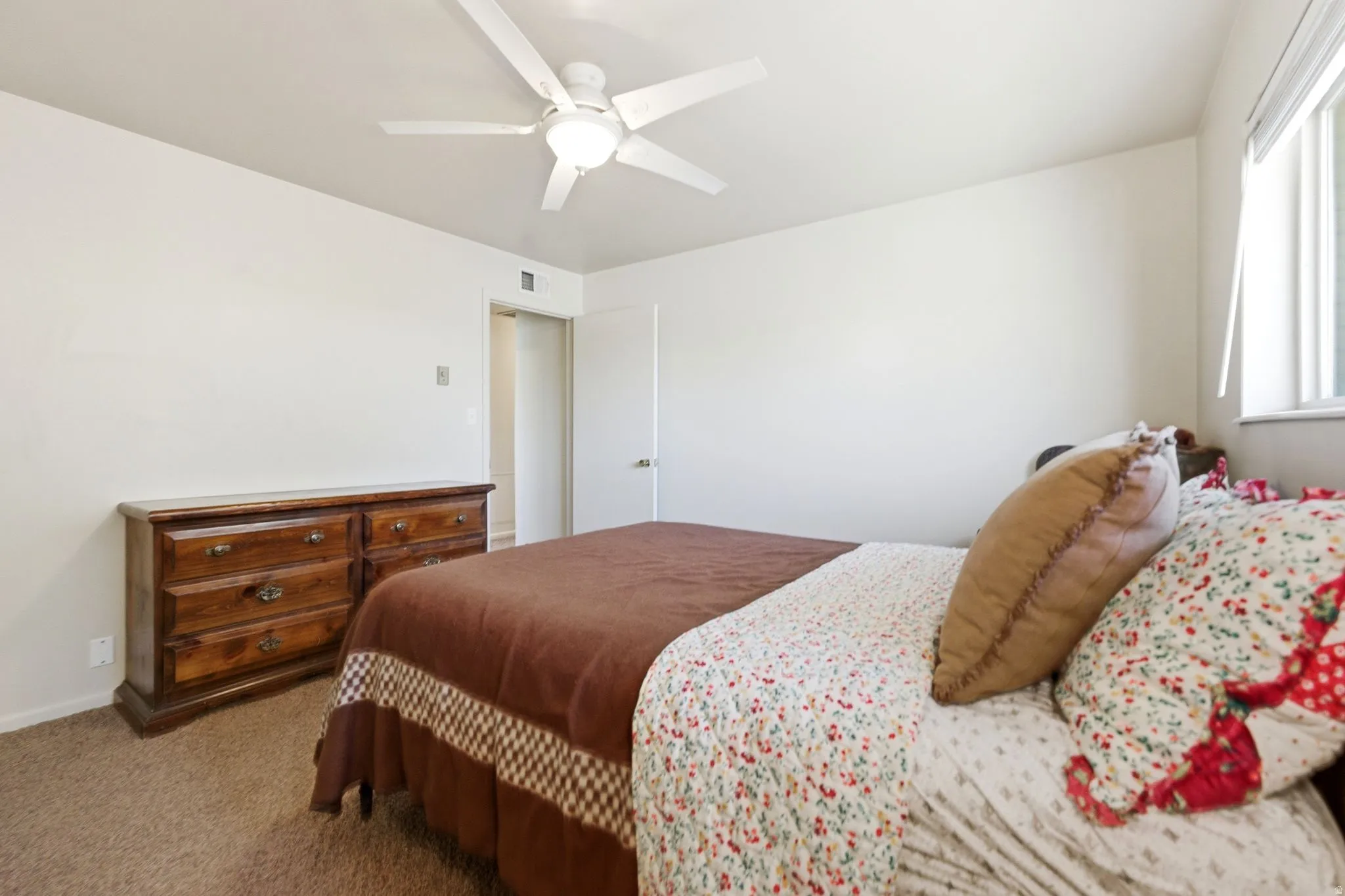 Interior room with light-colored walls and soft pile carpeting