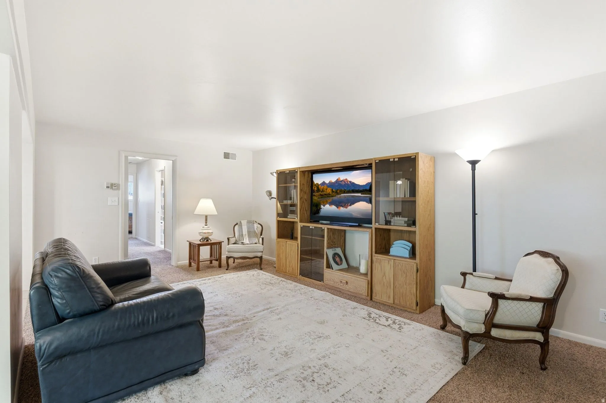 Living area featuring neutral carpeting and light-colored walls